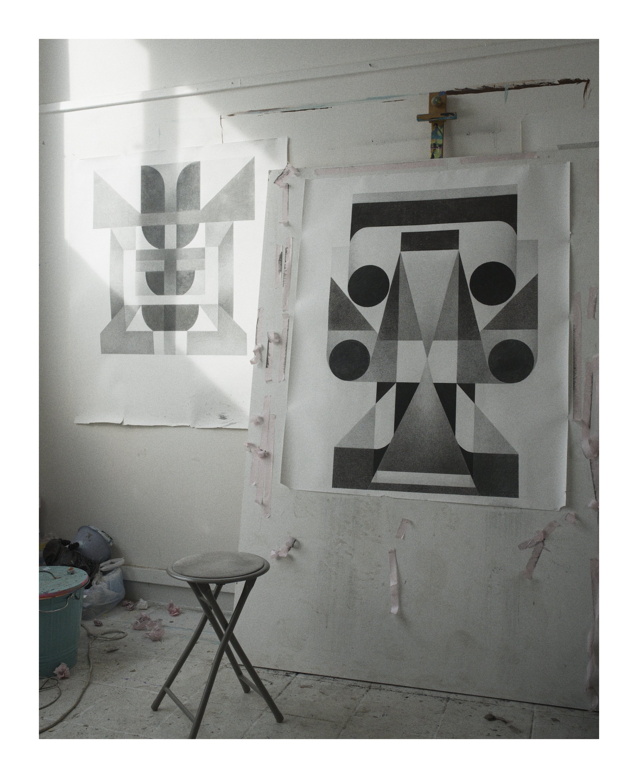 two charcoal drawings in a studio.