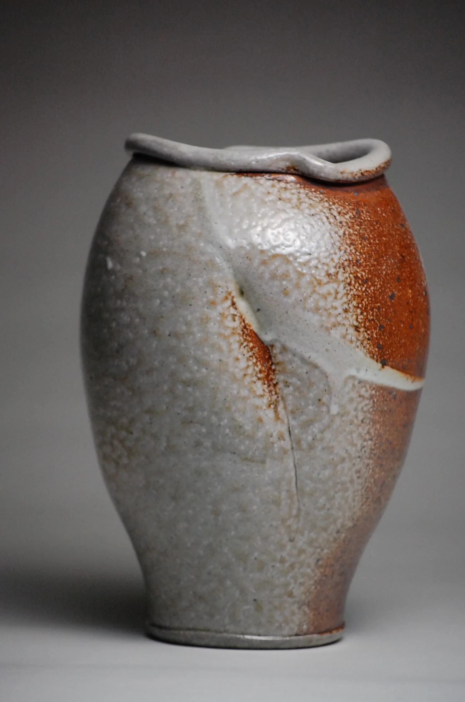 Soda Fired Vase with a Shino flashing slip. 7x8x12 