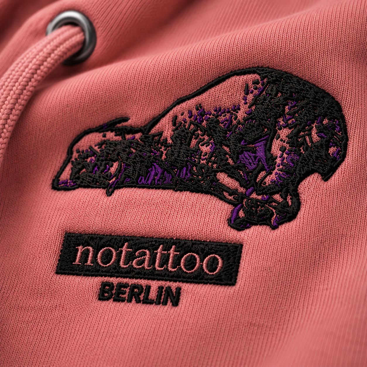 Close-up of embroidered Agnus Dei artwork on Dirty Rose hoodie by noSHBerlin, inspired by Francisco de Zurbarán, tattoo culture, and classical religious imagery.