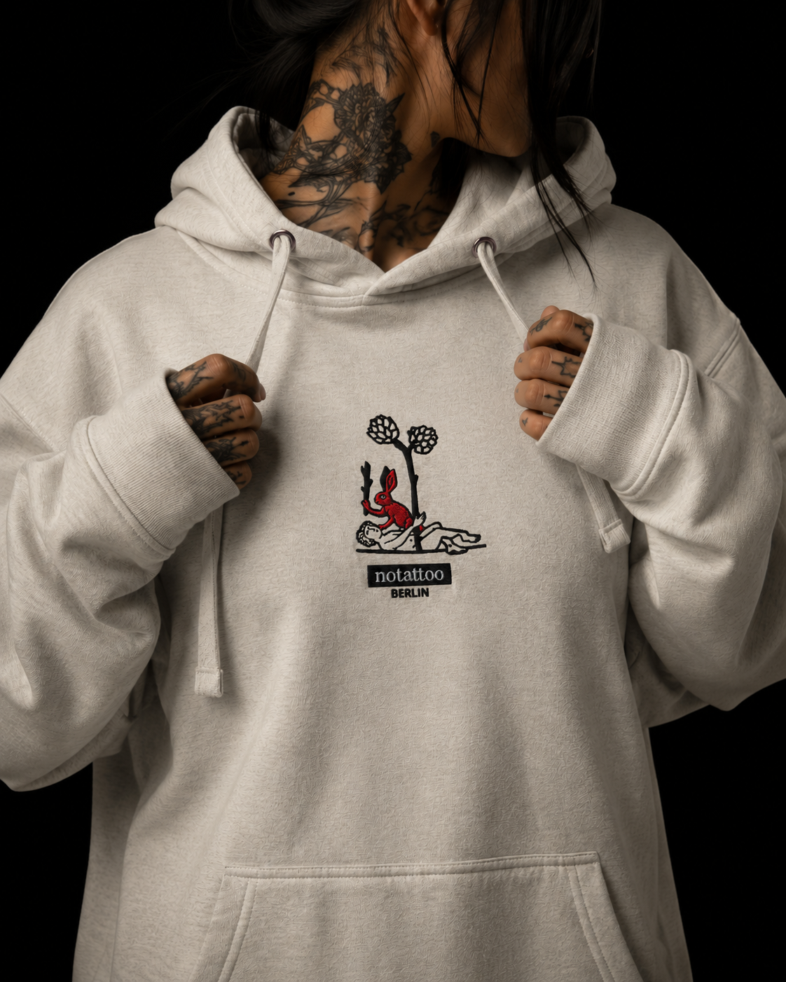 Front portrait detail of Basic Grey Medieval Killer Rabbit Hoodie by noSHBerlin, showing embroidered rabbit artwork inspired by tattoo culture and medieval manuscript imagery.