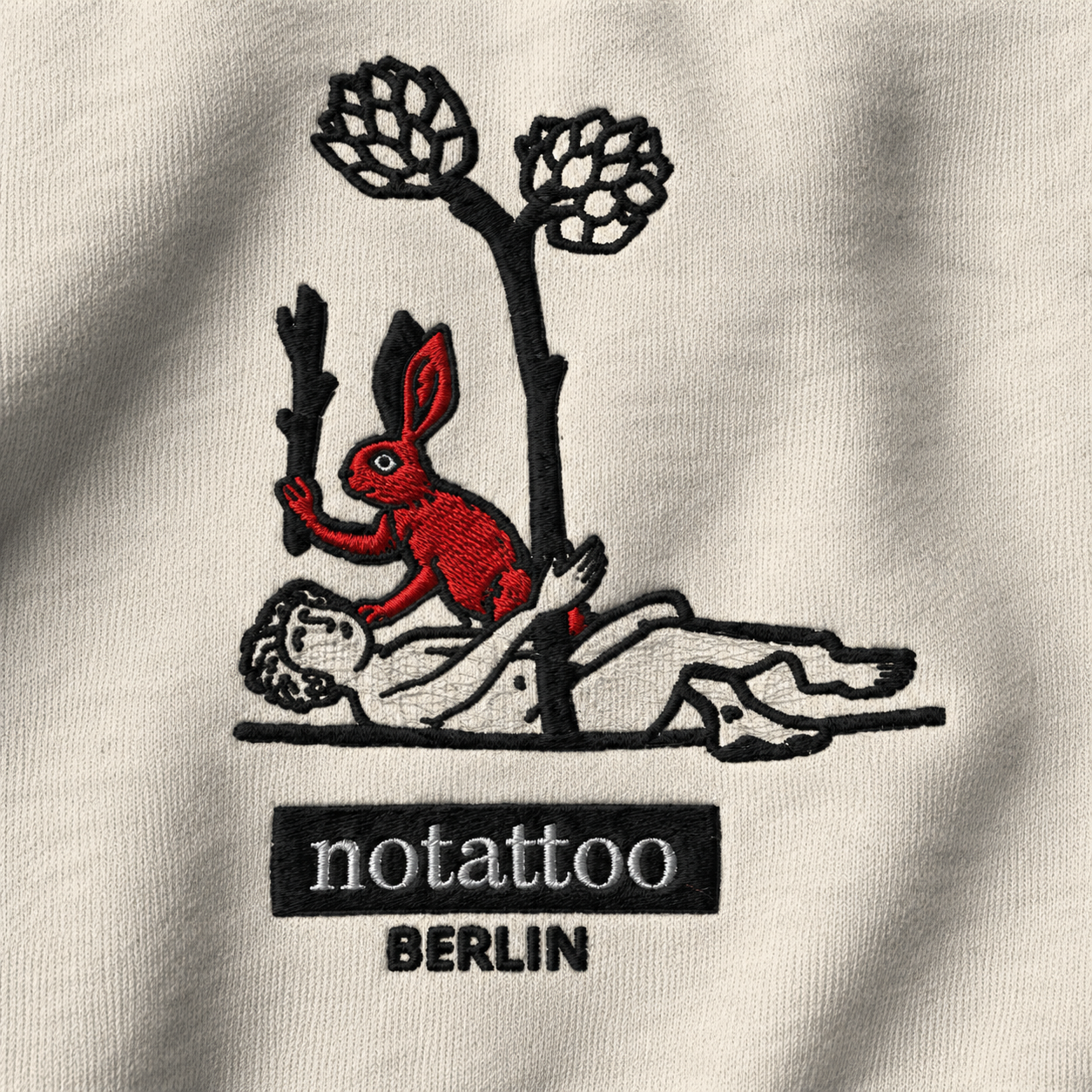 Close-up of embroidered medieval killer rabbit artwork on Basic Grey hoodie by noSHBerlin, inspired by tattoo culture and medieval manuscript imagery.