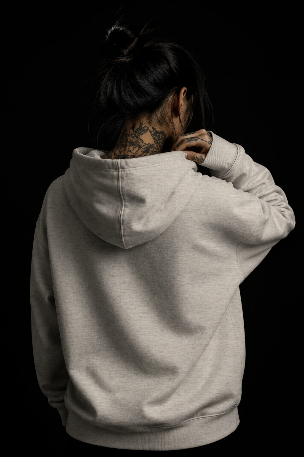 Back view portrait of Basic Grey heavyweight hoodie by noSHBerlin, showing the oversized hood and minimal rear design against a dark studio background.