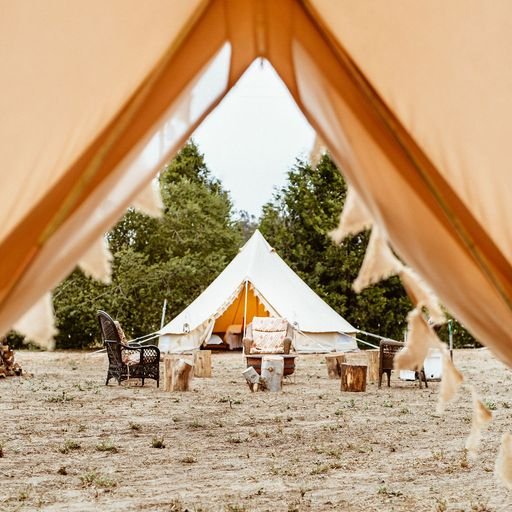 Luxury glamping village setup with fire pit, styled tent, and lounge seating in Los Angeles — services available nationwide