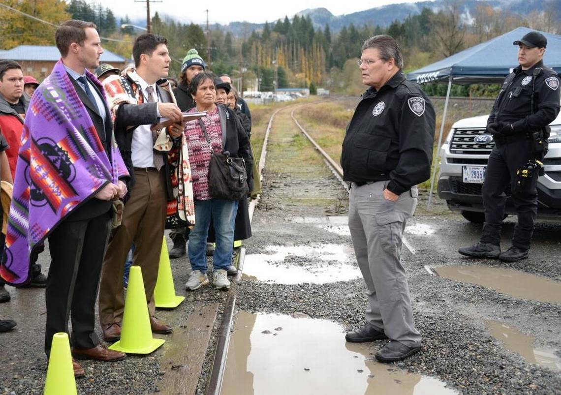 Ryan Dreveskracht and Gabe Galanda, at left, at Nooksack, facing off with the Tribal Police Chief