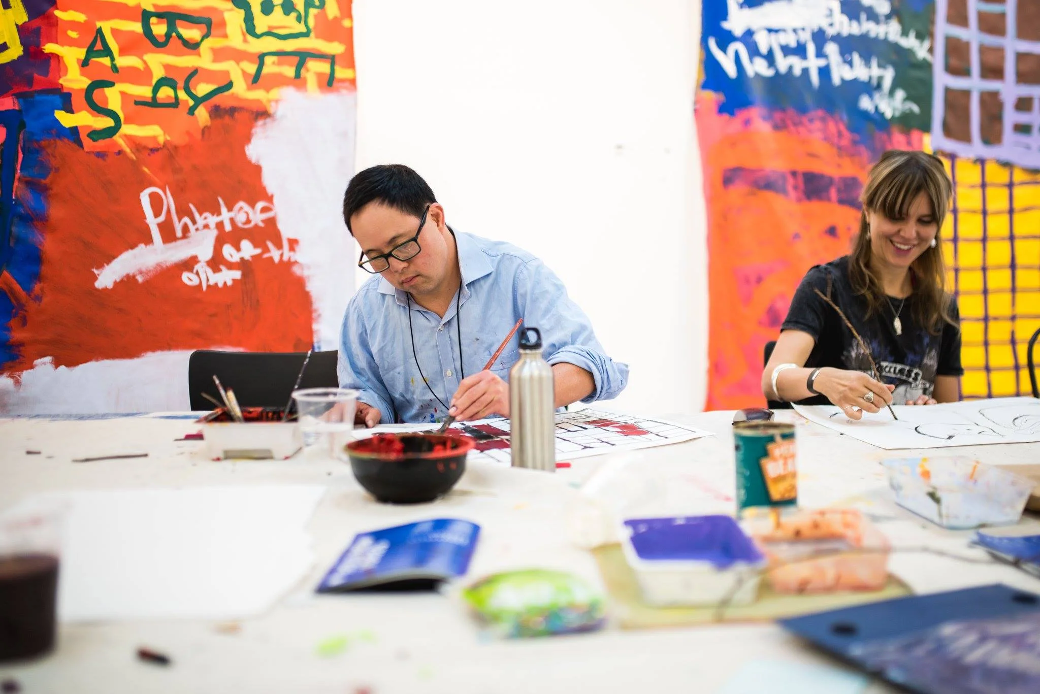 Image: Studio A supported artist, Damien Showyin, leading a painting workshop.
