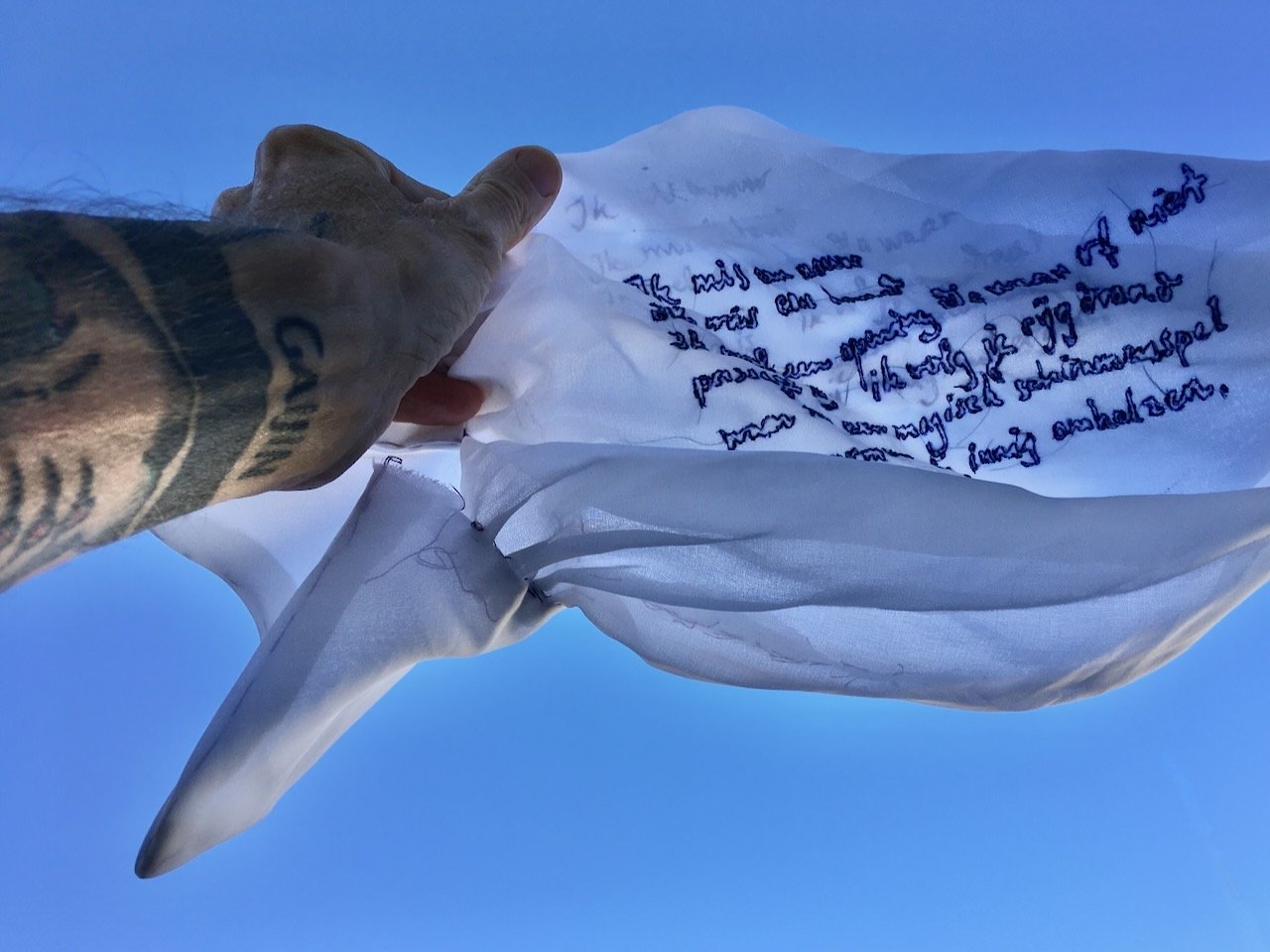 twice embroidered poem in the handwriting of the poet.words by george moormann.for his installation and performance stof zijt gij (dust art thou)
