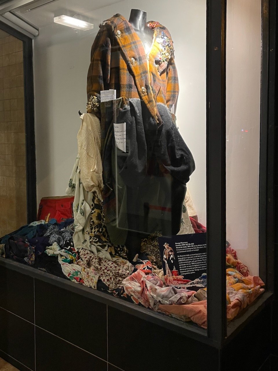  a coat for poetry made from several coats the mother of the poet george moormann had made. non of the coats were cut except the one that make the big grey pockets in front. buttons of her other clothes and watches were used to decorate (and not spil