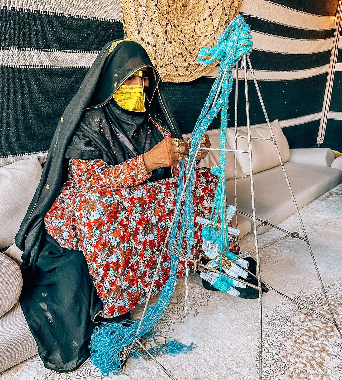The UAE&rsquo;s slow fashion started on a floor like this. In a tent, an Emirati artisan braids colorful threads 🪡🧵 on a tripod. No machines, no shortcuts. Just memory passed from women to women. Each braid is patience made visible, the rarest luxu