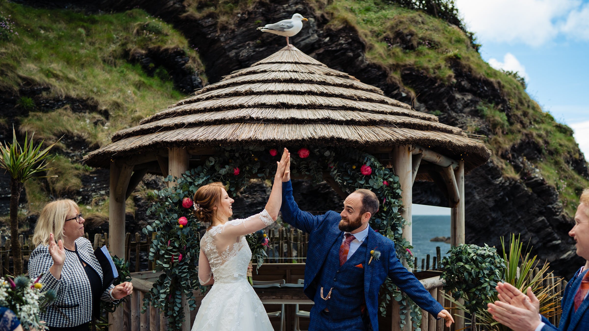bride - groom - tunnels beaches - seagull - high five - devon.jpg