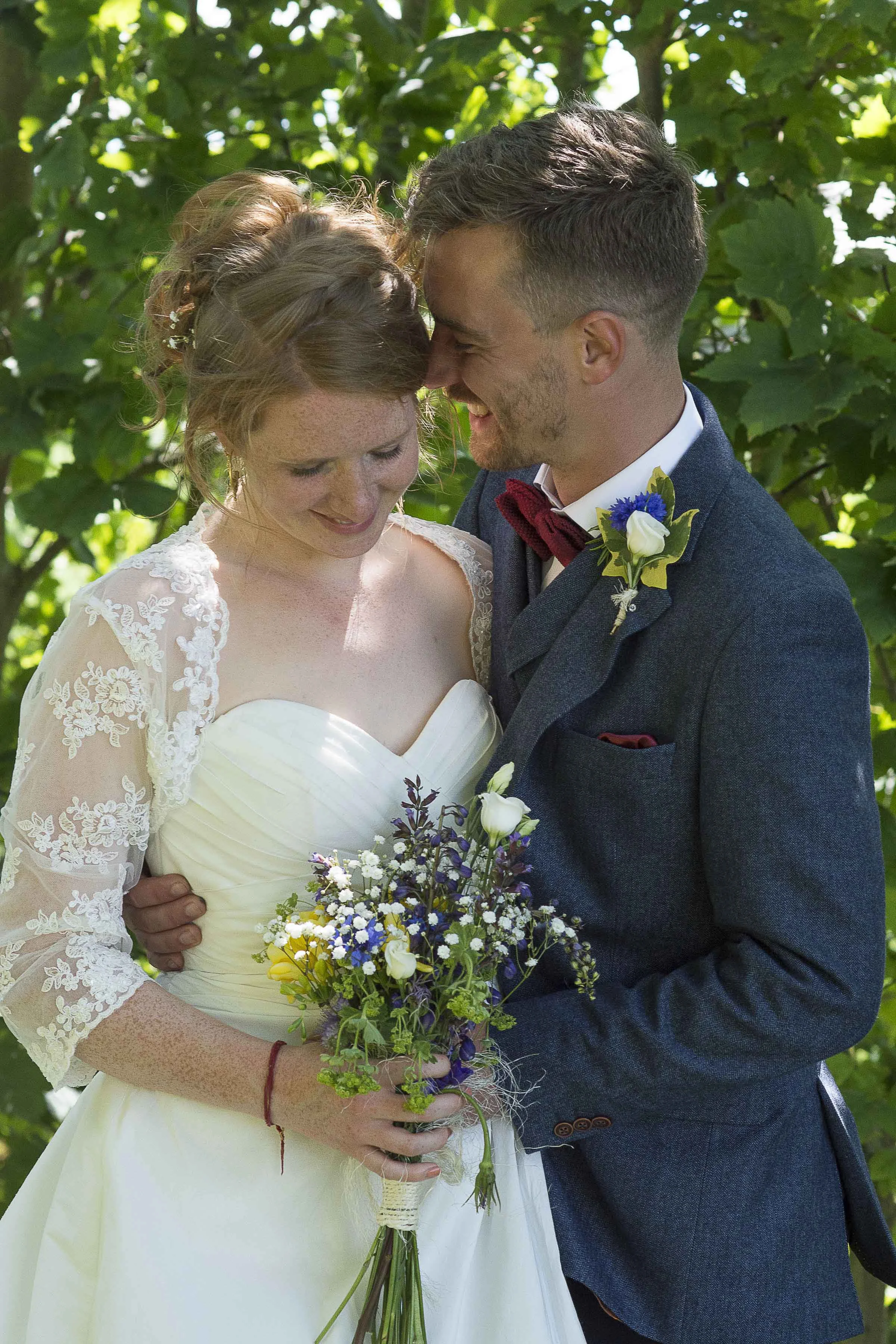 Groom whispering into bride's ear