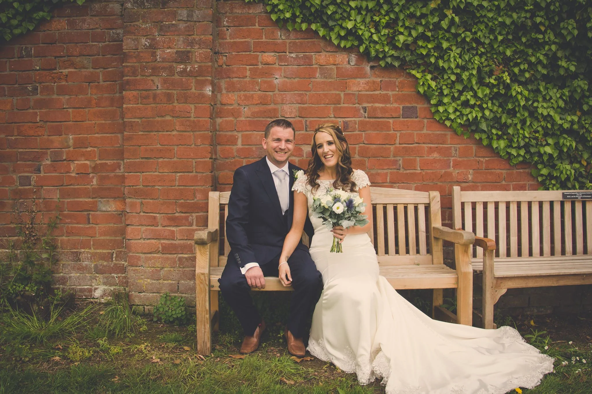 Bride and groom seated on a bench