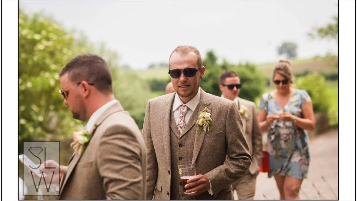 Man in sunglasses wearing tweed wedding suits