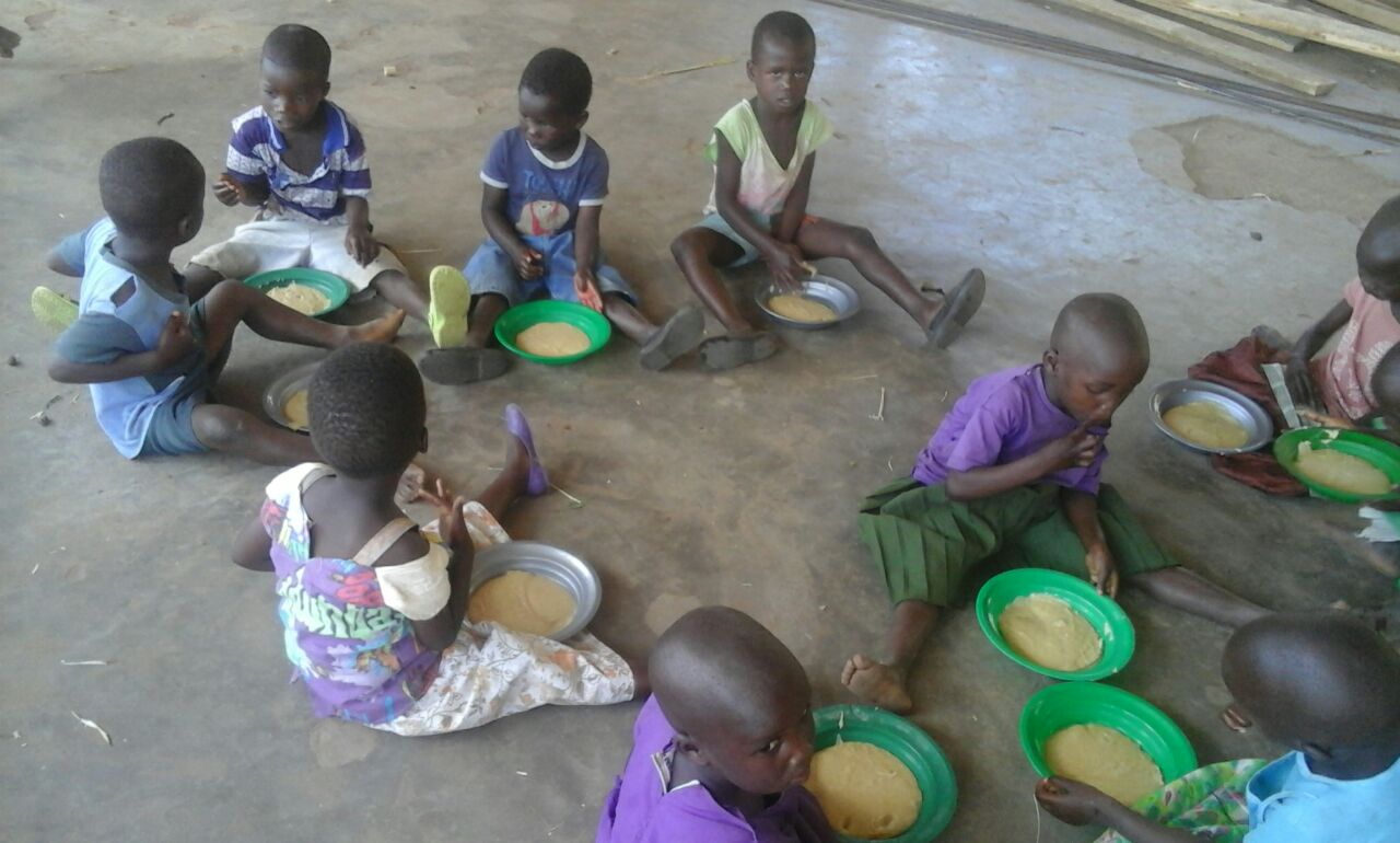 Kids eating Likhuni Pala (locally produced, high nutrition porridge) at nursery school.
