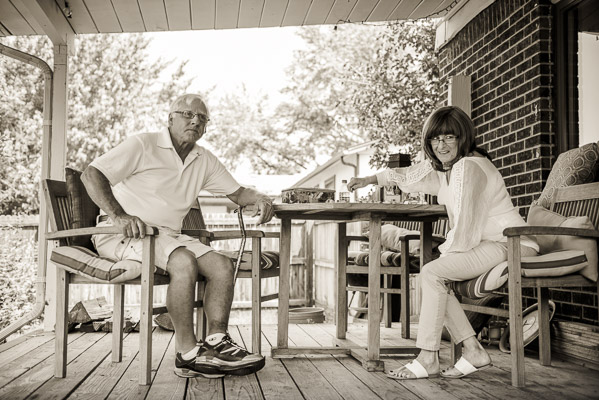 Grandparents sitting at a picnic table.