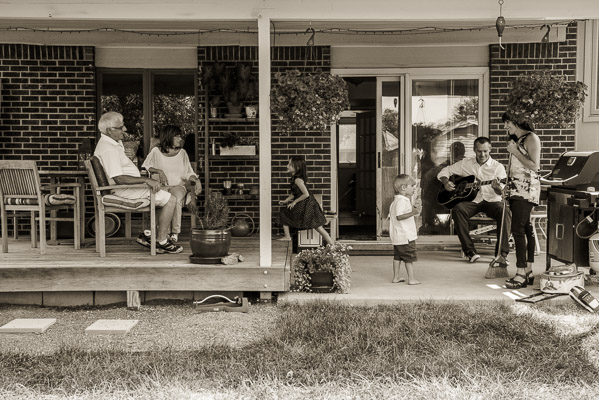 Family playing on a porch.