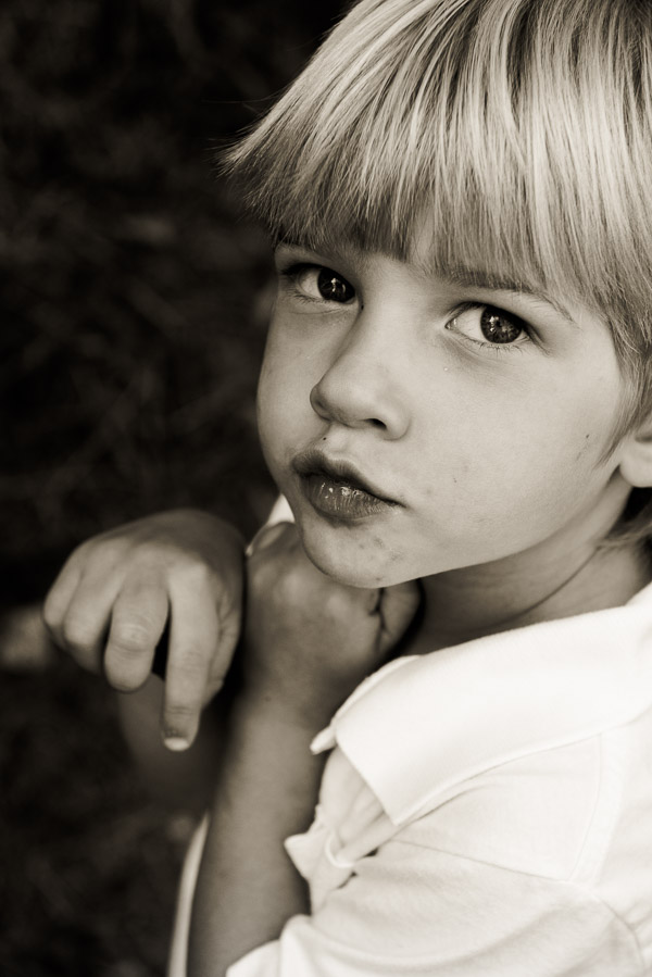 Adorable blone boy looking serious.
