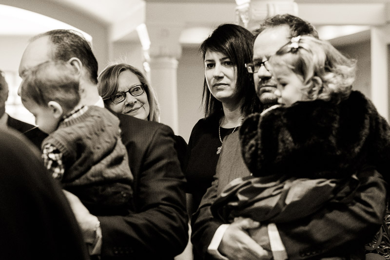 Grandmother watching as her grandchildren participate in baptism