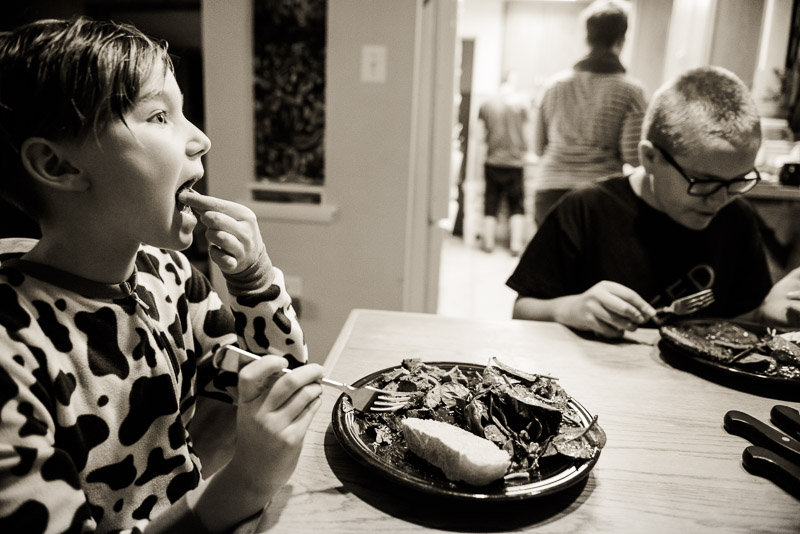 Girl eats her dinner.