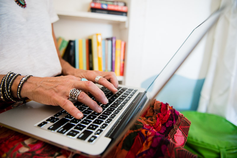 Woman's hands working on laptop keyboard - denver blog photography