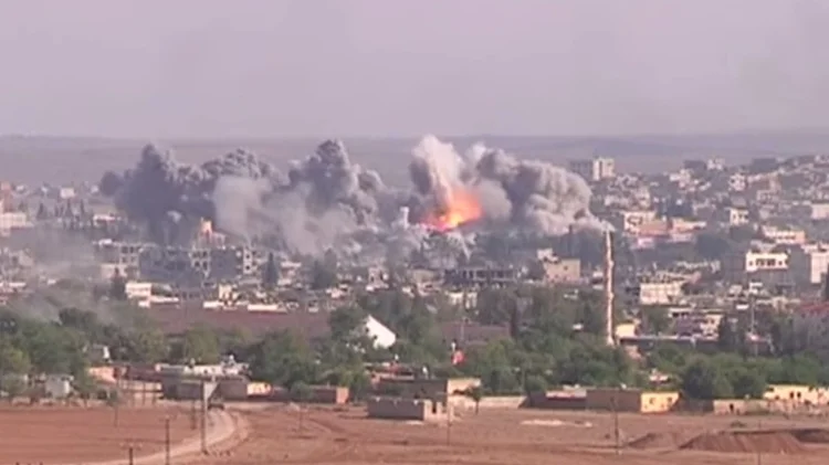 Coalition Airstrike on an Daesh position in 2014. Image Credit: Public Domain (Screenshot from Voice of America) via Wikimedia Commons