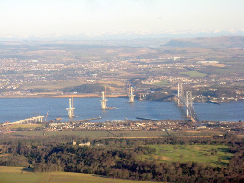Aerial view of the Firth of Forth towards Fife. At left is the emerging Queensferry Crossing adjacent to the FortH Road Bridge. Image Credit : © Copyright M J Richardson and licensed for reuse under this Creative Commons Licence