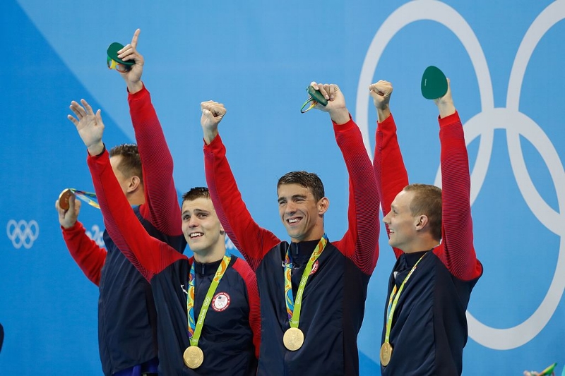 Michael Phelps and other members of the US Men's 4 x 100m freestyle swimming team after winning gold in Rio. Image Source: Fernando Frazão/Agência Brasil via Wikimedia Commons CC