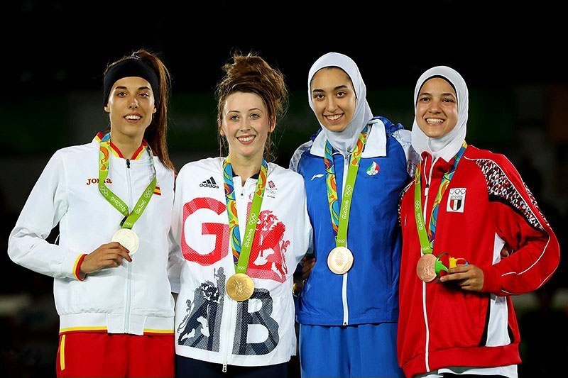Jade Jones (second from left) alongside her fellow medalists after defending her taekwondo title in the women's 57kg. Image Source: Mohammad Hassanzadeh/Tasnim News Agency via Wikimedia Commons CC