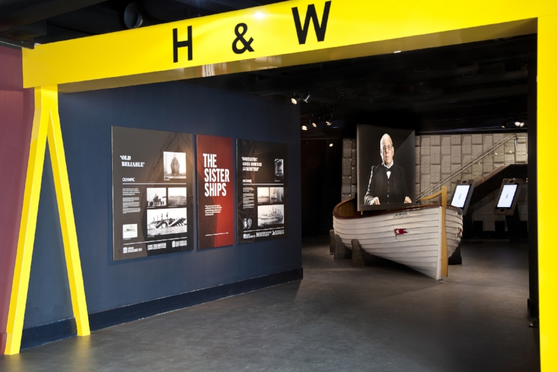 The Aftermath Gallery featuring a replica lifeboat and representation of the present-day Harland and Wolff gantry cranes. Image Credit: Titanic Belfast via Flickr CC