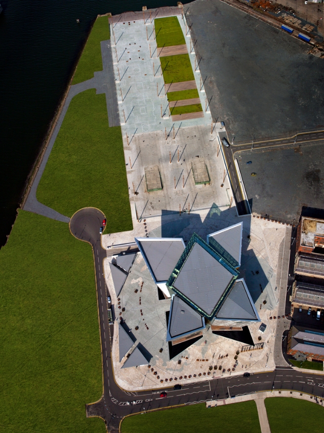 Aerial view of Titanic Belfast, with the slipways ( Olympic's on the right and Titanic's on the left) above it and the Drawing Offices to the Right. Image Credit: Titanic Belfast via Flickr CC