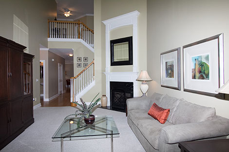 With only a single flash you see very hard shadows under the coffee table and on the staircase. The long hallway, above the stairs, and the kitchen in the background all look dark. The color is also very uneven as you move farther away from the flash.