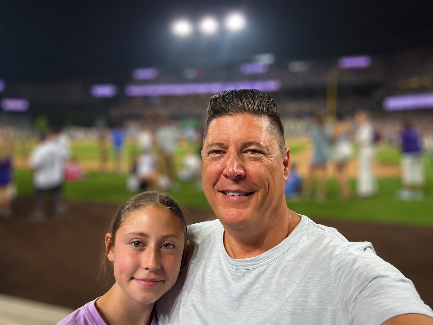Founder of Tek Ease with his daughter at a baseball game.