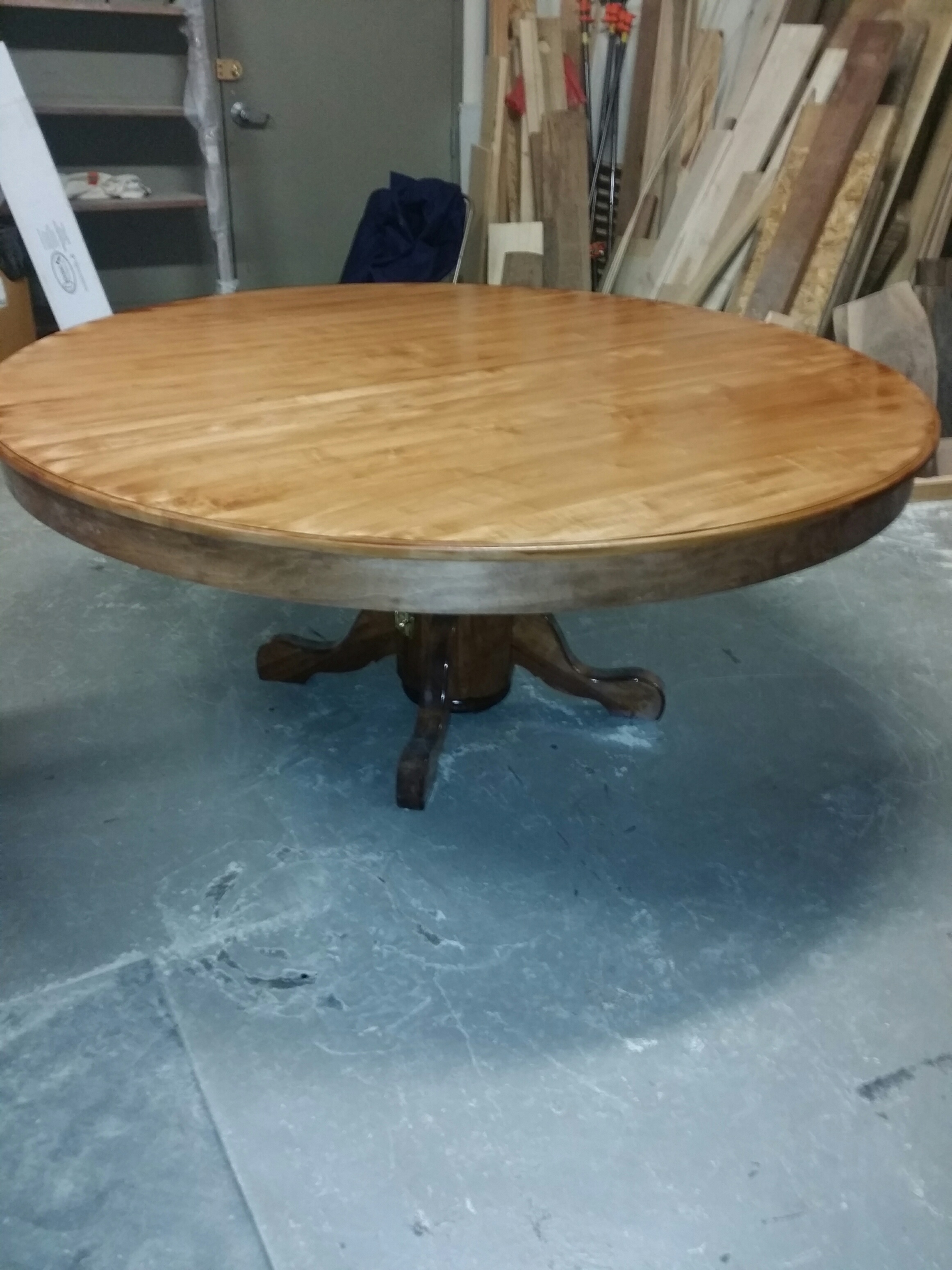 This photo shows the table in its closed position (during production). The pedestal is split vertically and held closed by clasps. To extend the table, you release the clasps and pull the table apart. Each half-pedestal rides along with its half of the table. Inside the pedestal is a smaller pedestal that remains centered and provides support for the center of the table. The pedestals are attached to an undercarriage that supports the top and all the leaves. Believe it or not, the table can easily be fully extended and closed by one person.