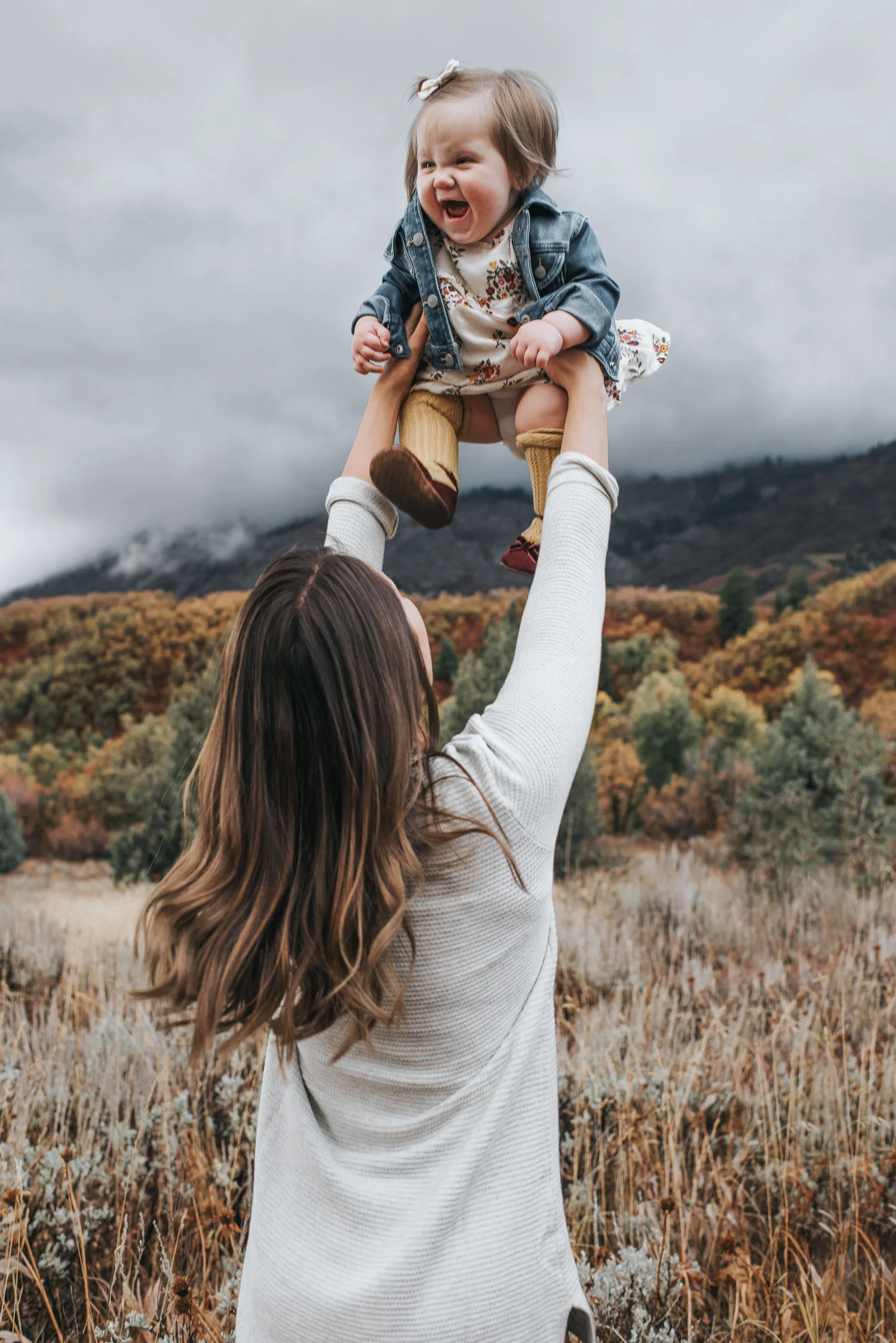 A mother playing with her babe, taken in October, during an extended family session.