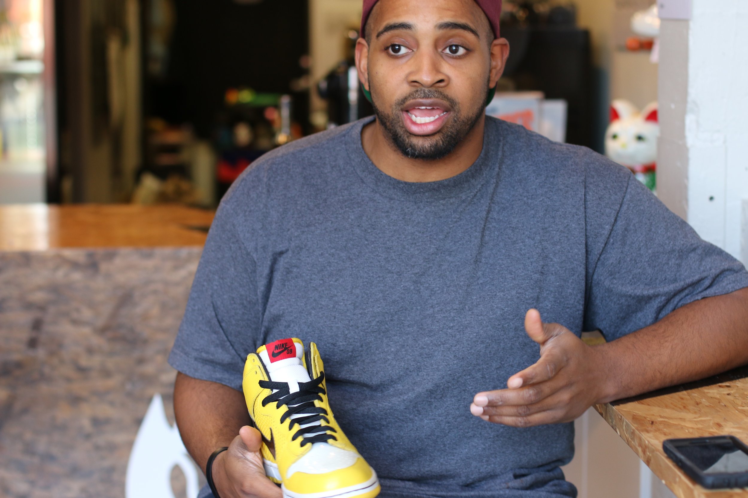 Ian with the first shoe he designed for Nike, inspired by the "wet floor" signs he used to put up when he was a custodian
