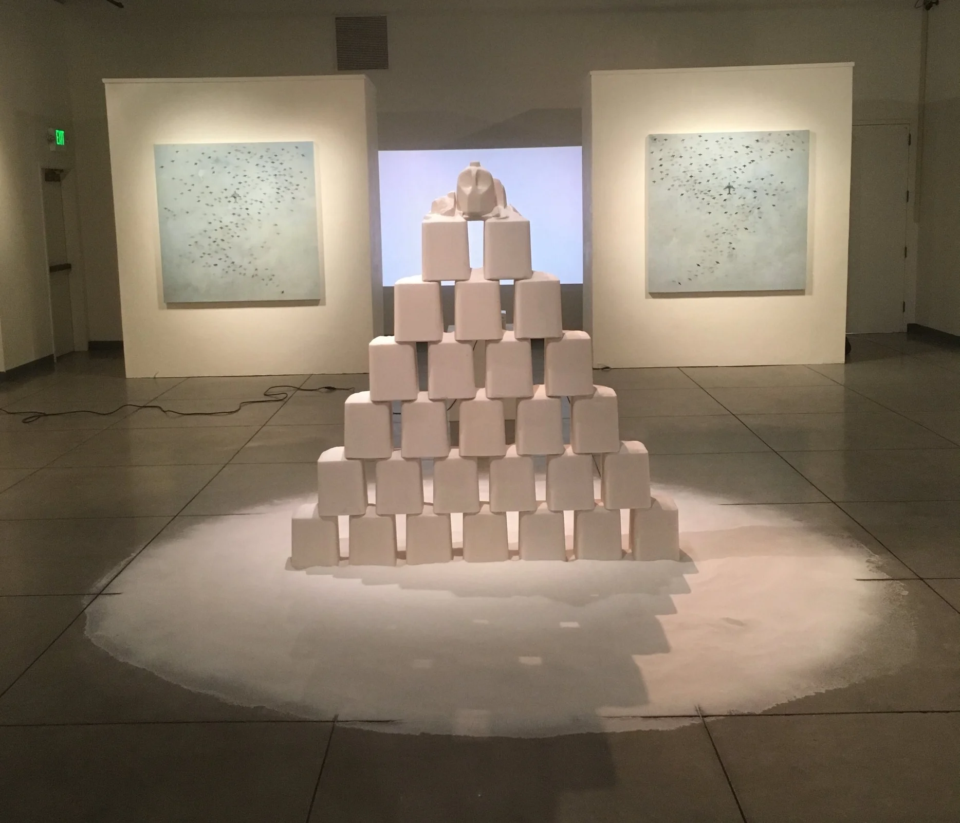 Flight Pattern (2 paintings and a audio/video component) behind Salvation during install. Projector was ceiling mounted getting rid of any and all cords.
