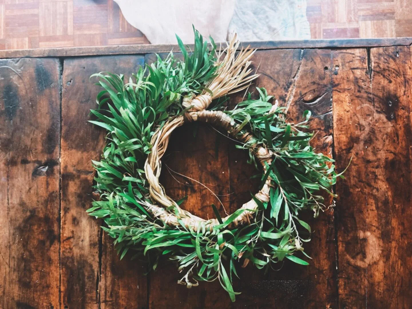 celebrating life cycles
.
she saw our neighbours door
and wondered
so
from one cabbage palm spear
split dried soaked braided
with one gymea lily leaf 
split dried soaked wound
around callistemon branches
chosen snipped picked bundled
and in full circ