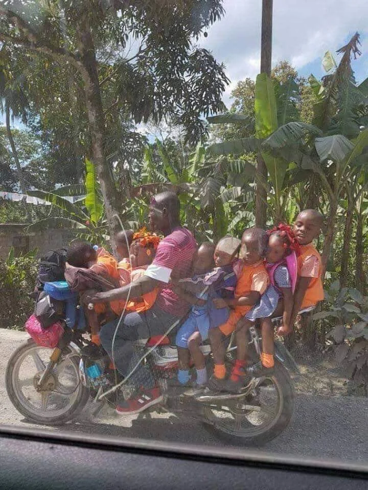 Eight kids on a motorcycle