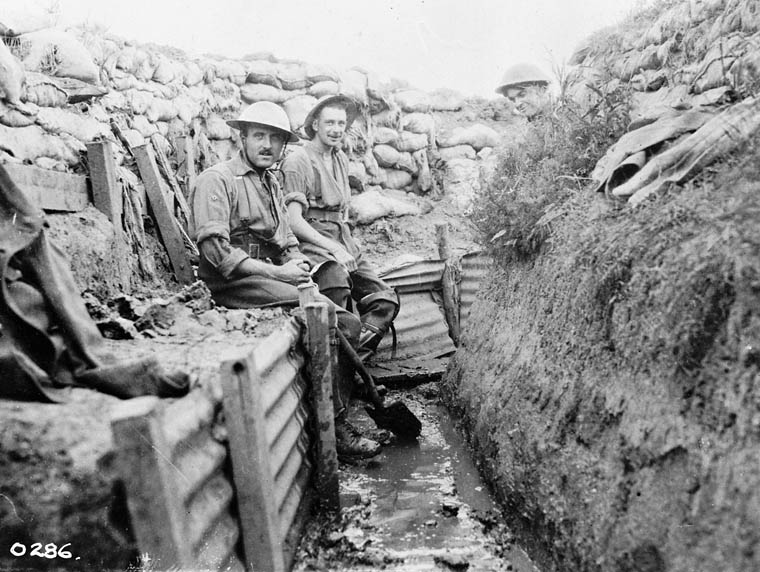 Trench maintenance. Men sitting on the 'Fire-step'.