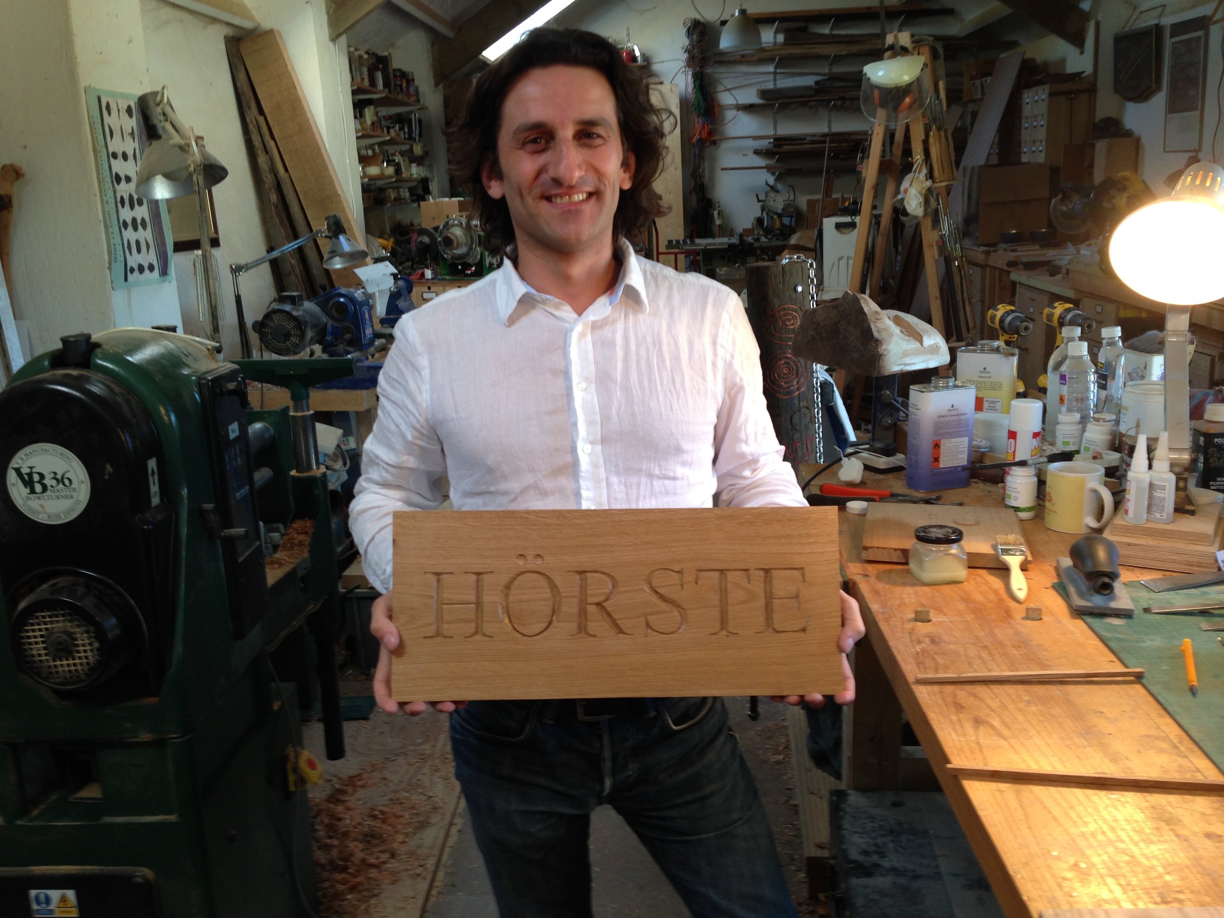 Student with his house sign - his first ever letter carving