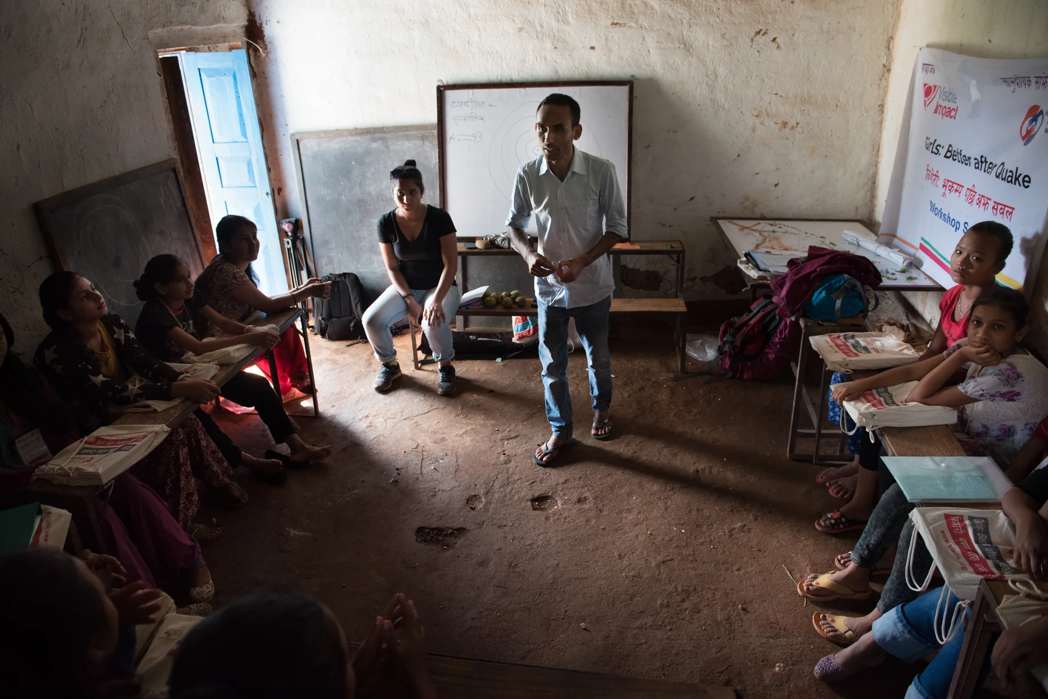 Accountability Lab's Suresh Chand and Samita Thapa talk to 15 girls at a school house in Nuwakot, Nepal about accountability and integrity. (Photo by Brittany Wait)
