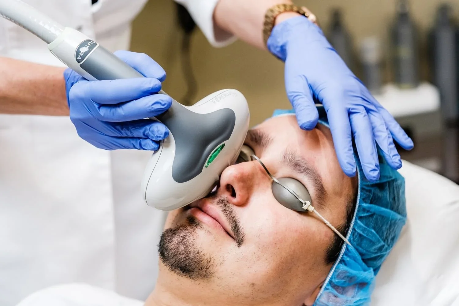 A man lays back as he receives a 3D Laser Facial.