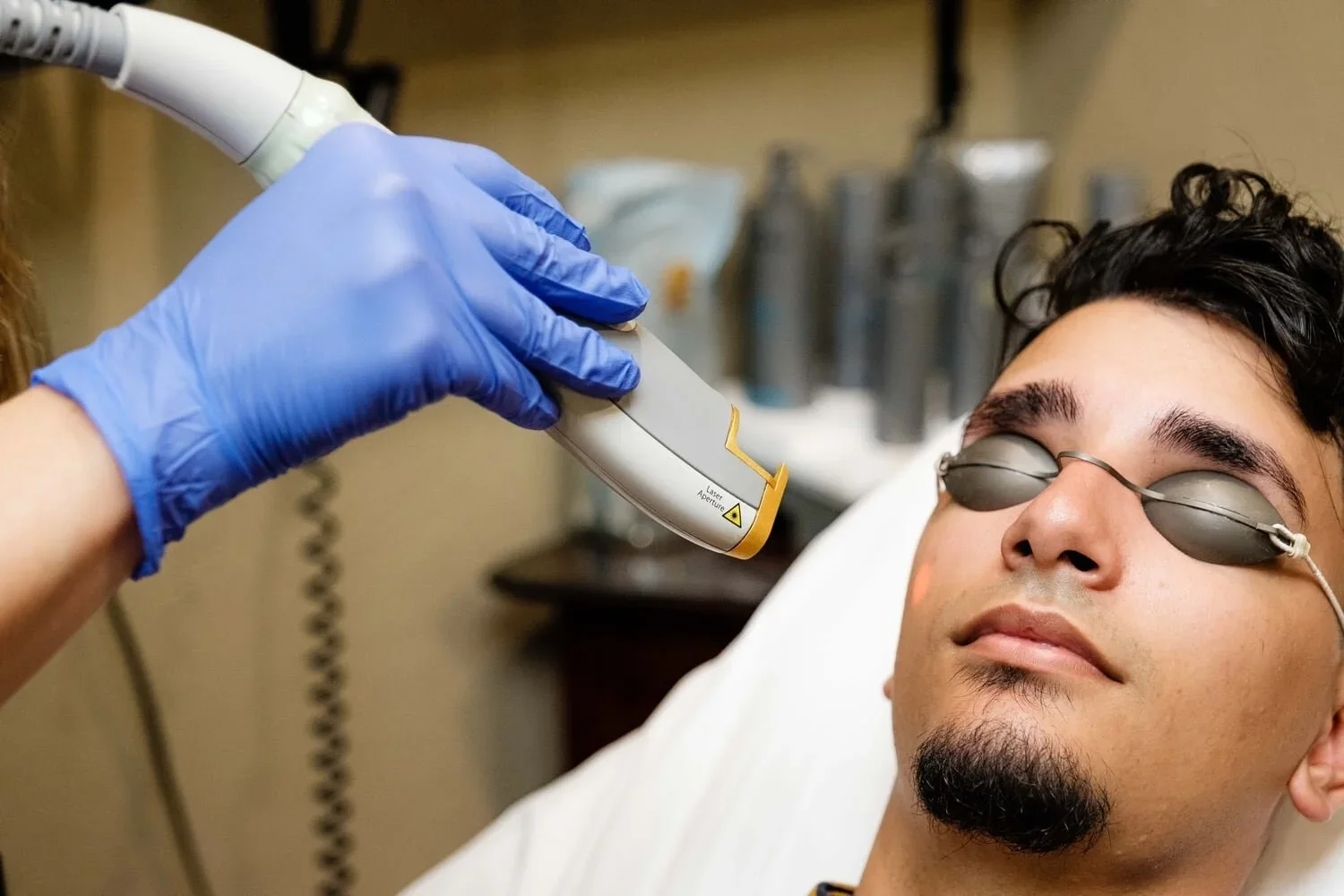 A man lays back in bed preparing for a laser genesis treatment.