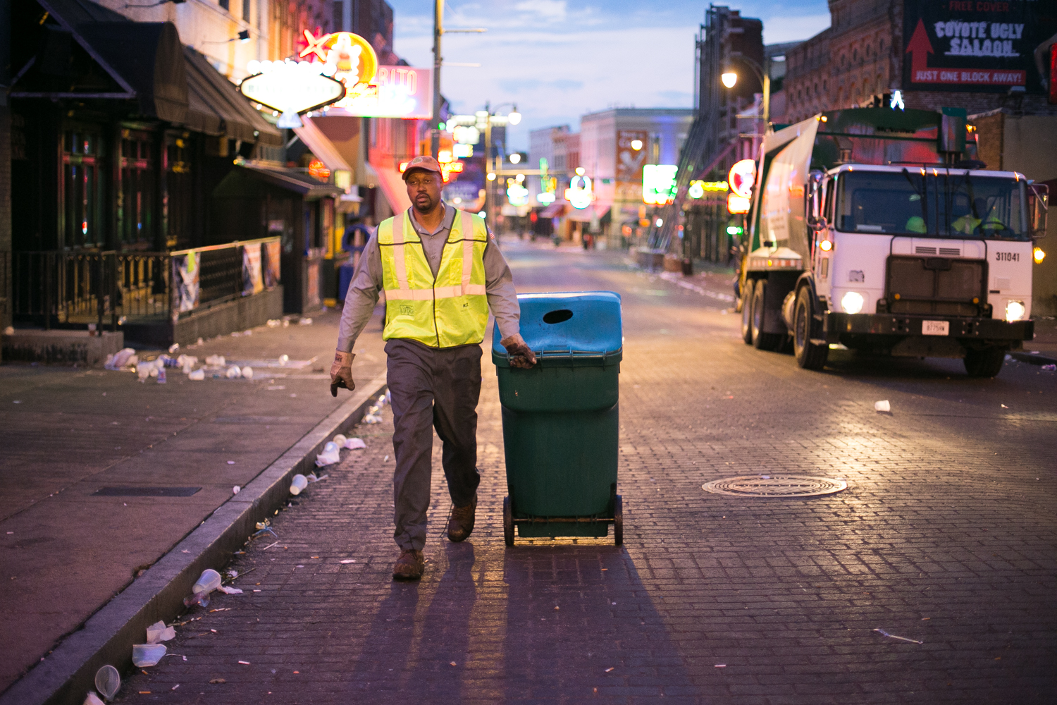 While most people are asleep in their beds, six-seven big Kevin is just finishing his clean sweep on Beale Street. He and his co-worker empty every last trash can that lines the Memphis party strip.