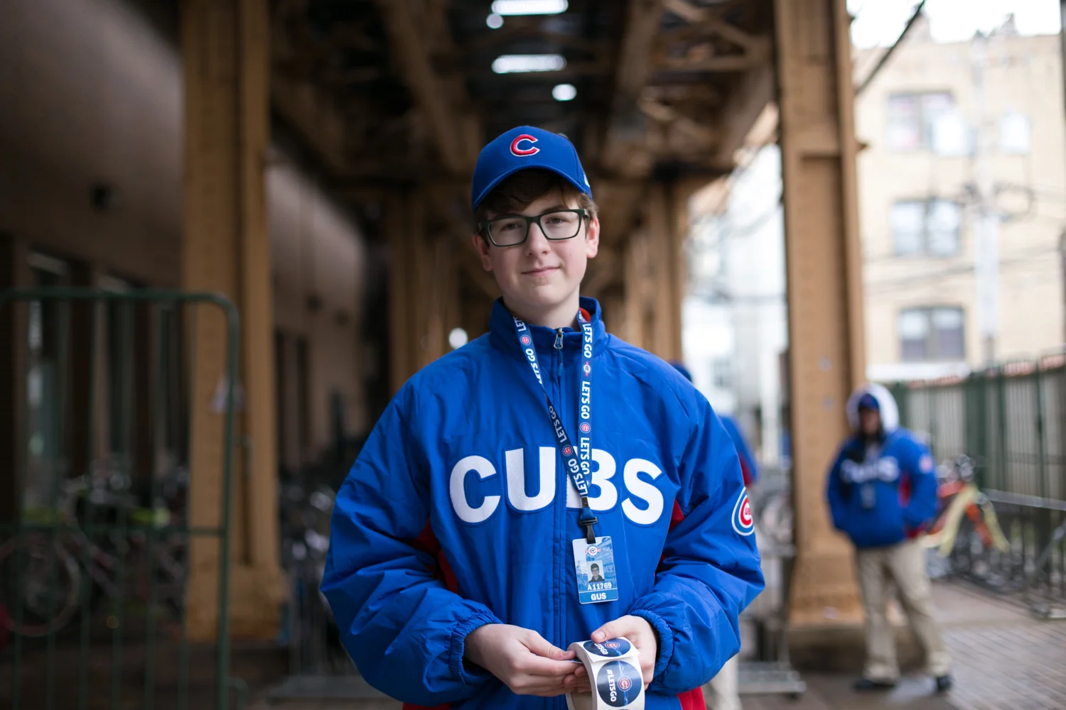 Gus hands out free stickers during his downtime at the bike check outside Wrigley Field. He's happy that his first job is working for his favorite team. 6/24 