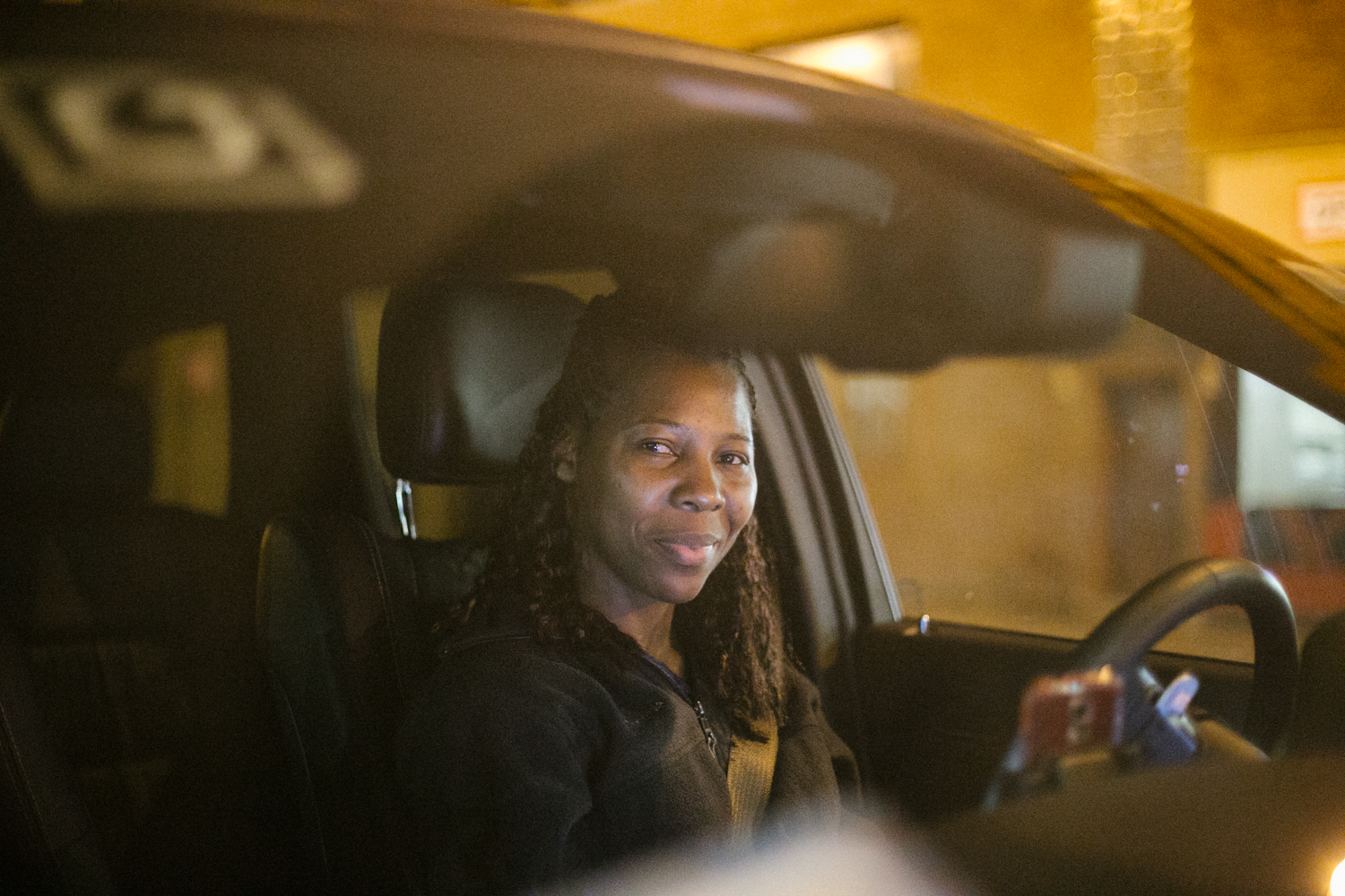  Efia, who was born in the Caribbean, raised in New York, has been driving for Uber for a year and a half. 30 rides given yesterday. 16/24 