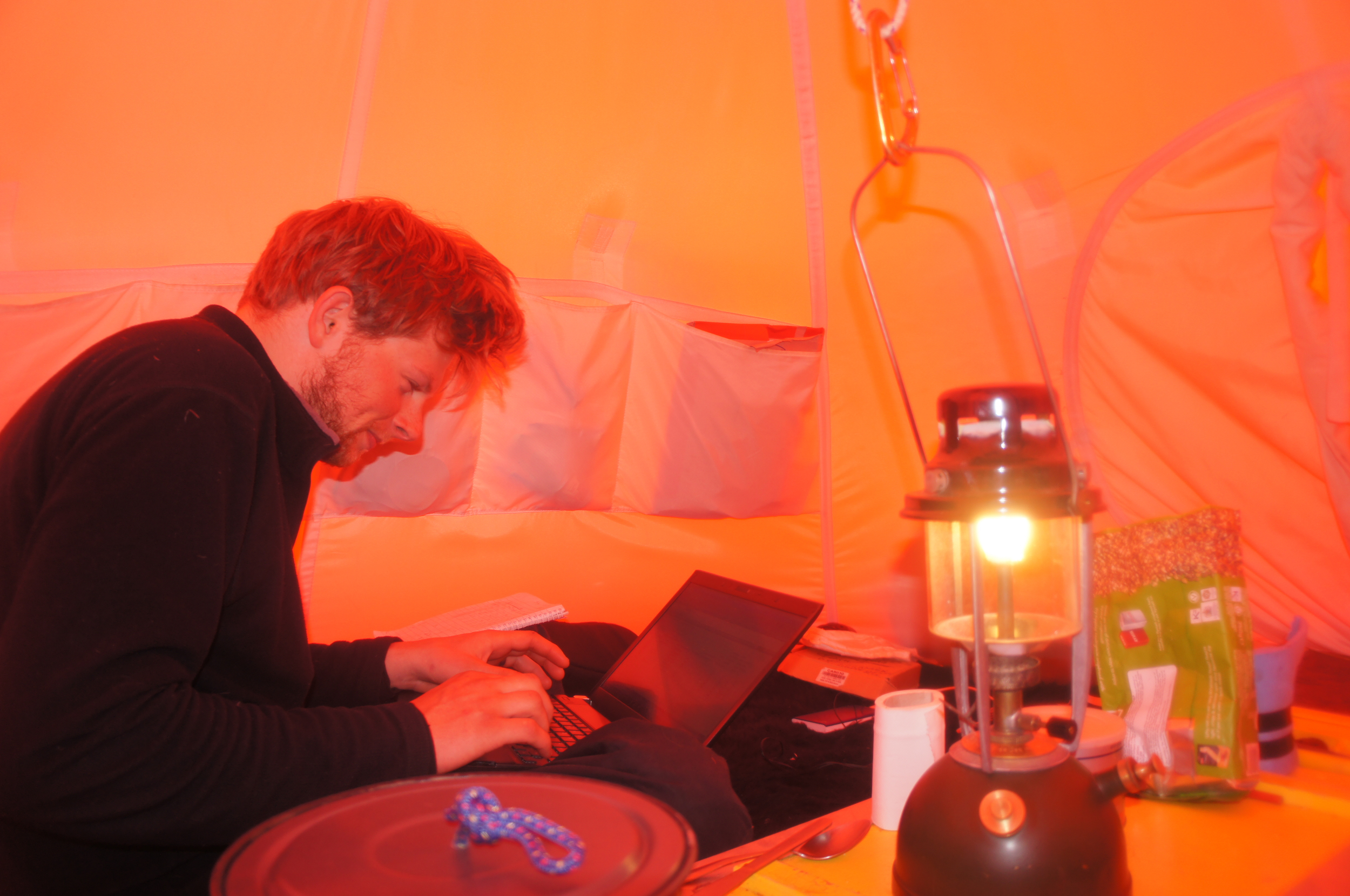 Dr. Kingslake hard at work in the tent