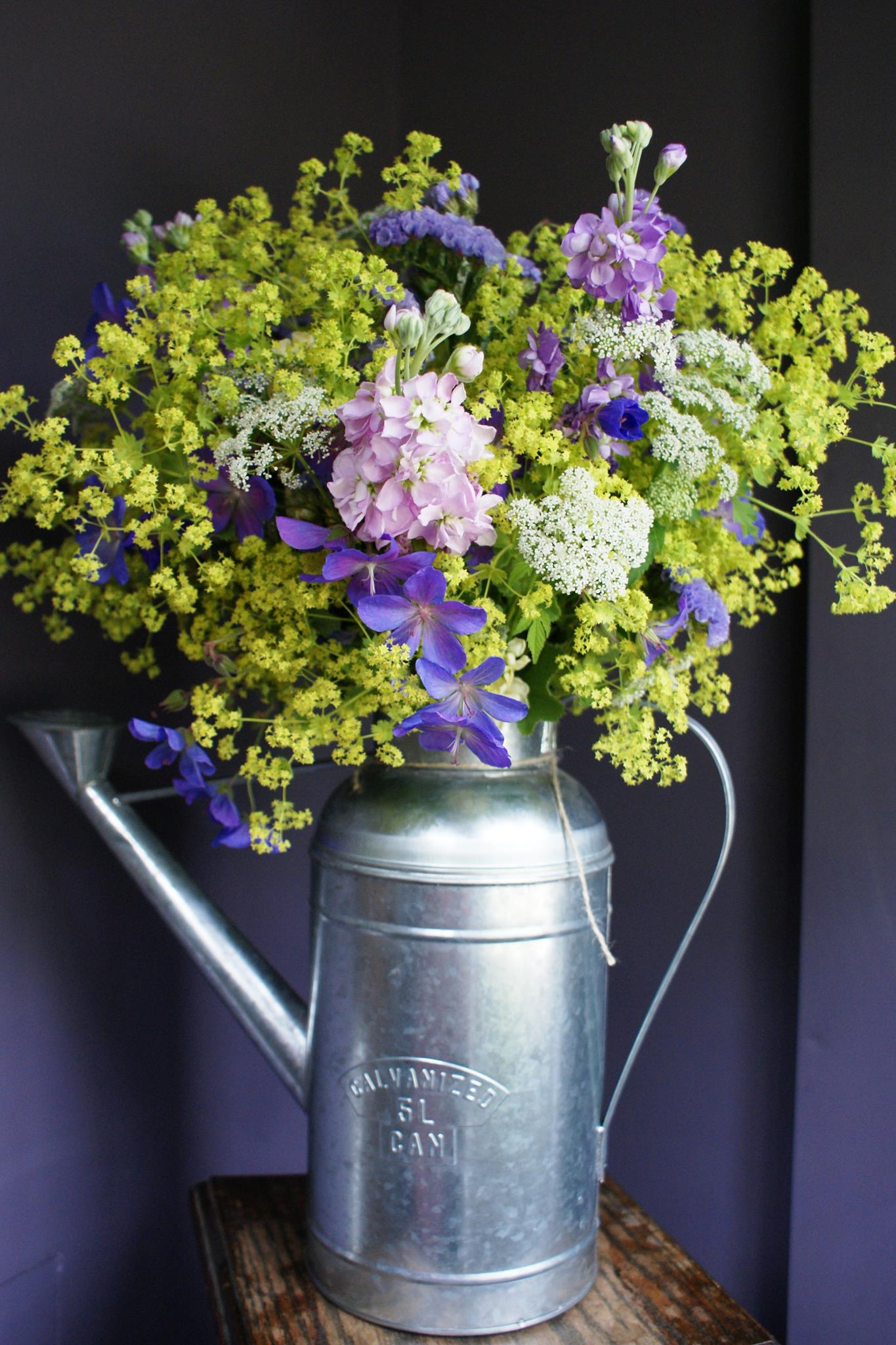 watering can filled with flowers