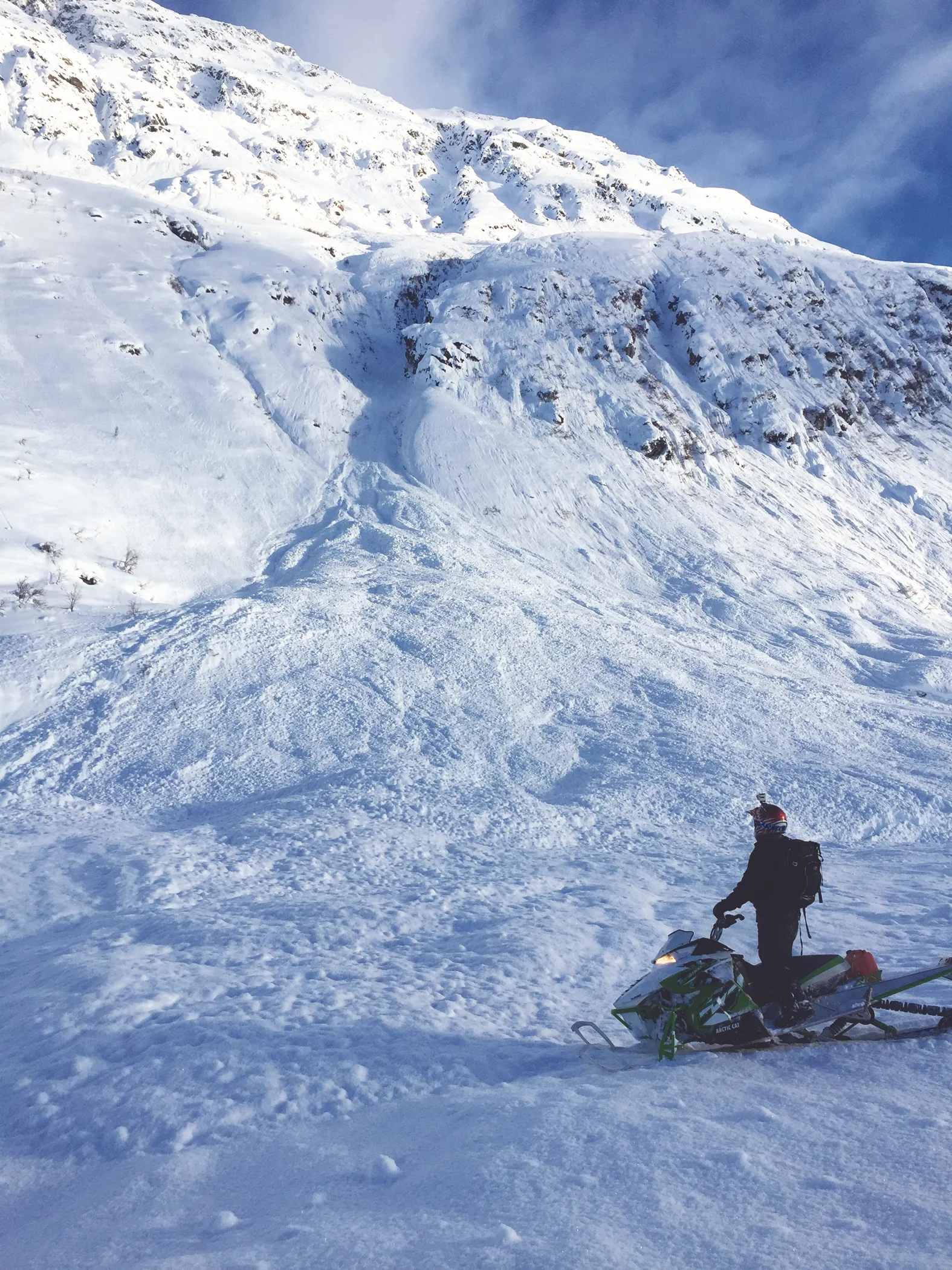  A snowmobile checks out the run out zone from an Avalanche in Hatcher Pass. Photo by S. Carter 