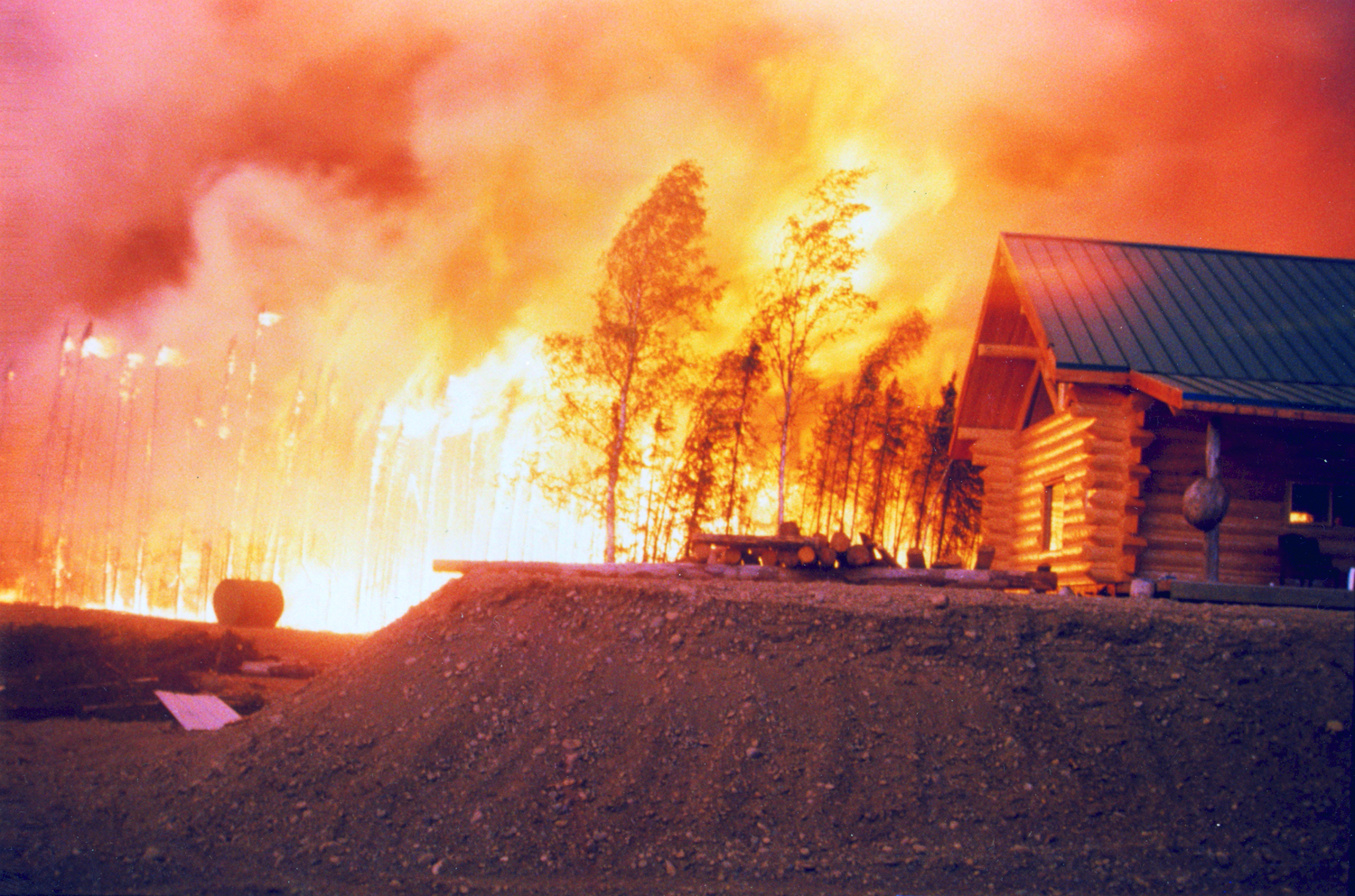 A home in the glow of the Miller’s Reach Fire. Photo courtesy of the Matanuska Susitna Borough Emergency Services.