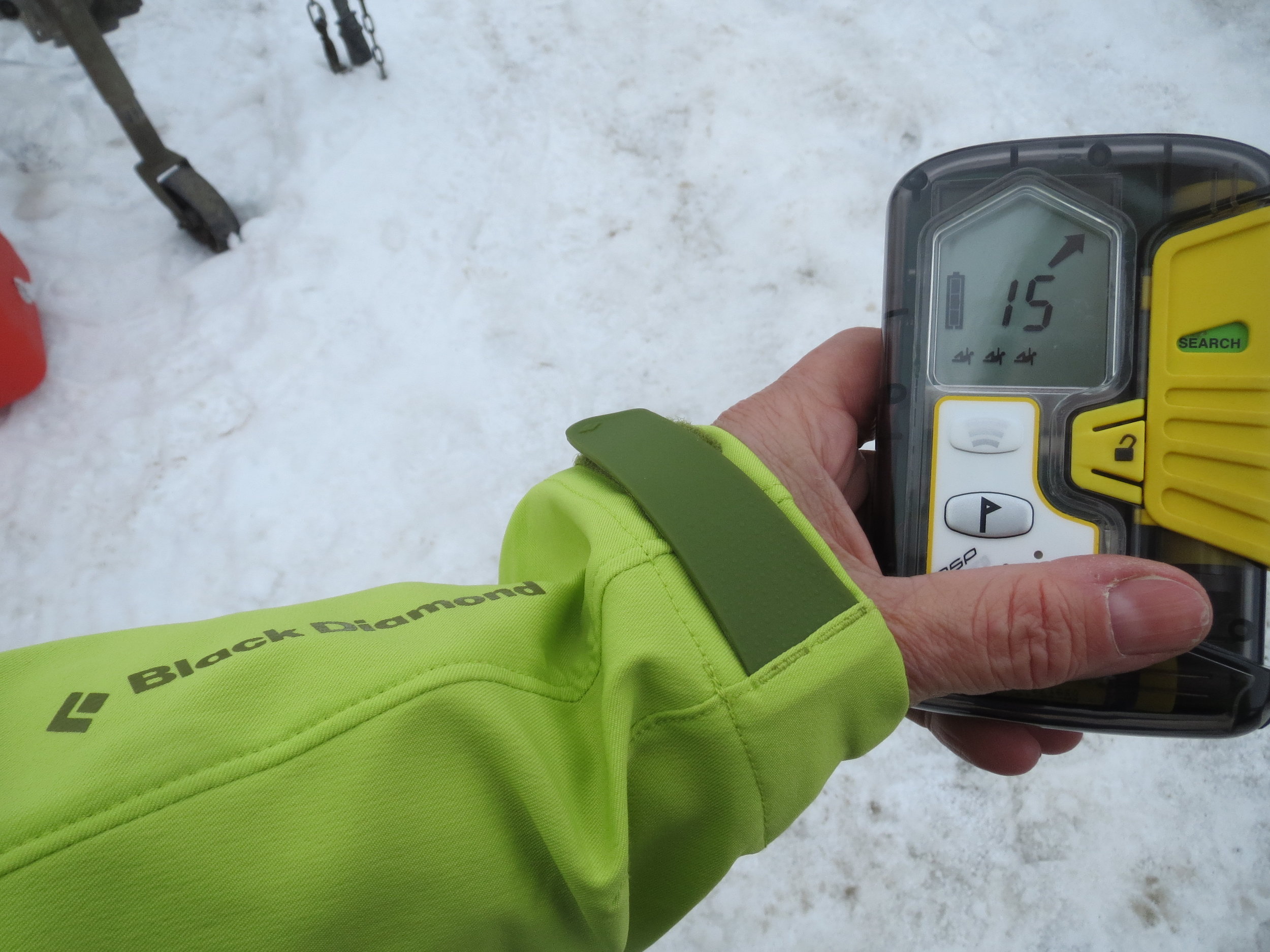 Using an avalanche transceiver to search for a buried victim. 
